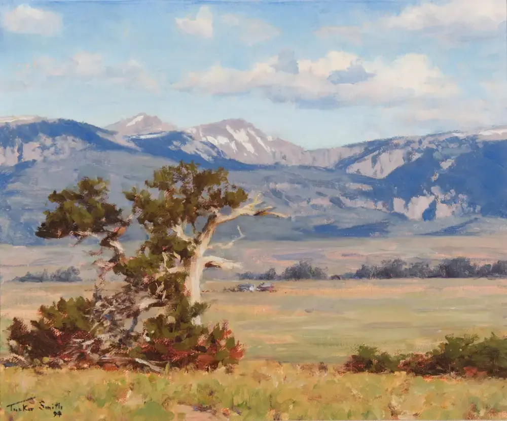 Oil painting of a windswept tree in the foreground with distant mountains and a blue sky beyond the valley.