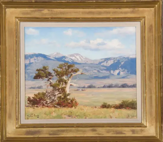 Landscape painting: a lone tree in a meadow with distant mountains under a blue, partly cloudy sky, framed in a gold frame.