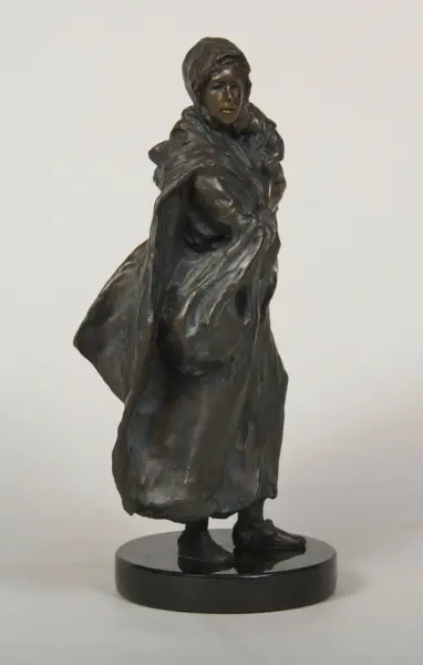 Bronze statue of a hooded figure in a flowing cloak standing on a black pedestal