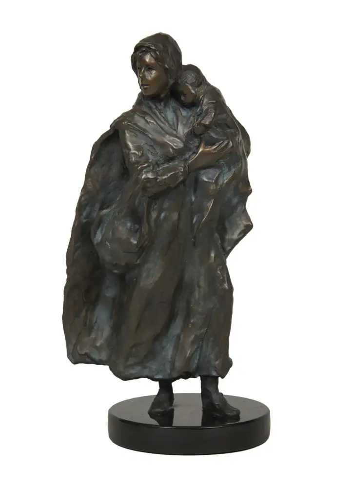 Bronze sculpture of a woman in a cloak holding a child on her shoulder, standing on a round black pedestal.