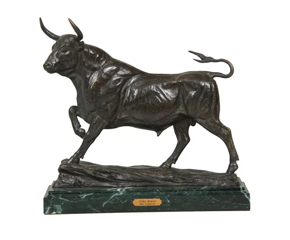 Bronze statue of a bull in mid-stride on a marble base with an inscribed plaque underneath.