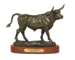 Bronze bull sculpture with a textured surface on a wooden base, serving as an award trophy edge plaque visible below.