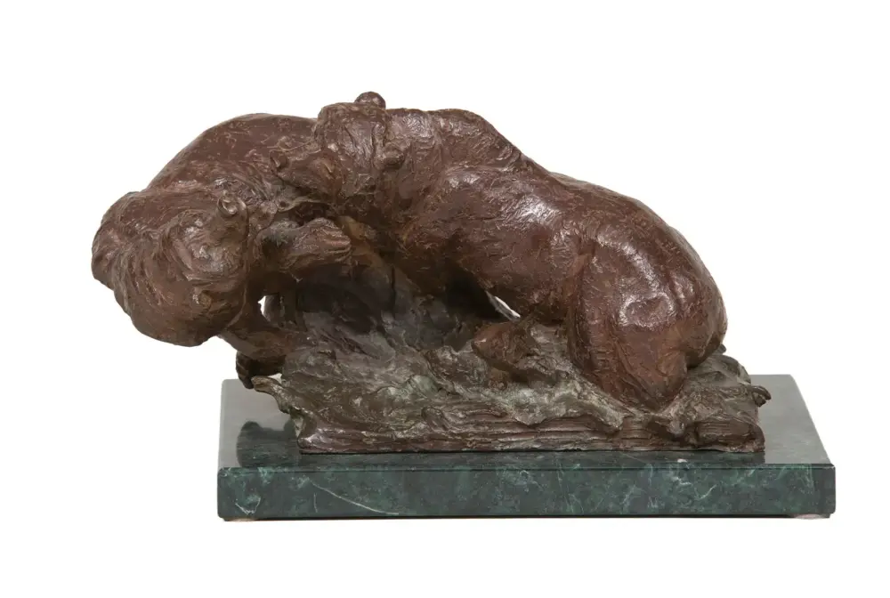 Bronze sculpture of a large dog curled up on a green marble pedestal base