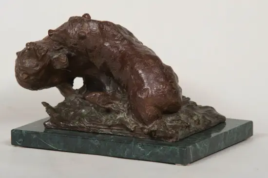 Bronze abstract sculpture of a contorted figure on a green marble base.