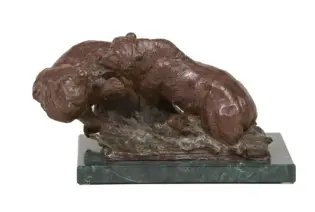 Bronze sculpture of a large dog curled up on a green marble pedestal base