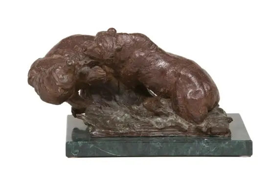 Bronze sculpture of a large dog curled up on a green marble pedestal base