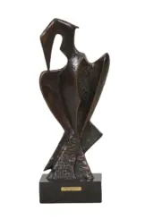 Bronze sculpture of a preening heron on a black pedestal with a small plaque on the base.