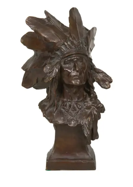 Bronze bust sculpture of a Native American man wearing a feathered headdress on a square pedestal.