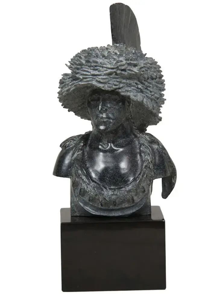 Dark stone bust of a man wearing a large feathered hat on a square pedestal.