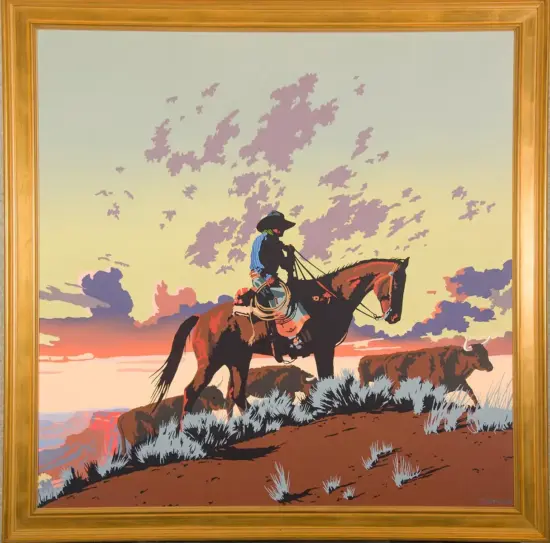 Cowboy on a dark horse riding along a hillside at sunset, with grazing cattle and a colorful sky in the background framed artwork
