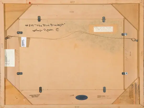 Back of a wooden picture frame showing a hanging wire, metal corner brackets, and various labels and stamps on the back panel.