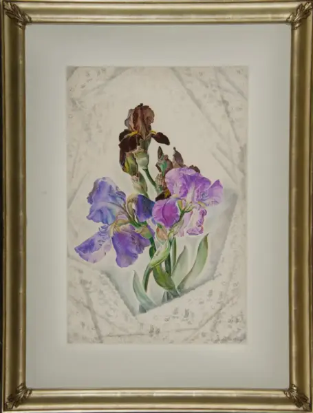 Ornate gold-framed botanical print of purple irises with green stems against a lace background, matted in white matting.