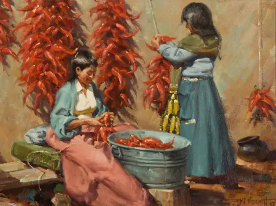 Two women working with red chili peppers around a metal tub in a rustic setting, one seated and sorting peppers, the other handling peppers on a string.]