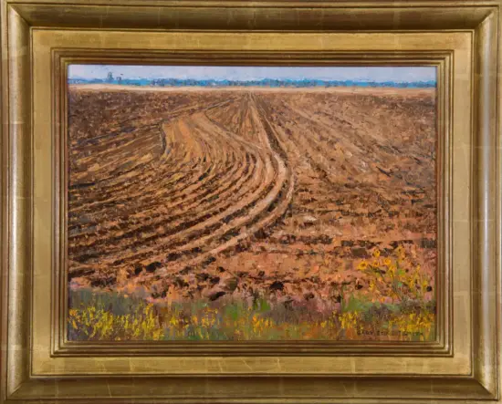 Oil painting of a plowed field with curved furrows stretching to the horizon under a blue sky, with yellow wildflowers in the foreground, in a gold frame.
