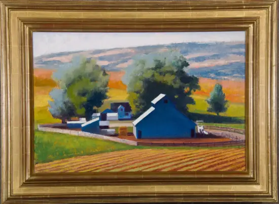 Rural landscape painting with blue barns, white fences, green fields, and orange-hued hills, framed in a gold frame.