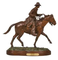 Bronze statue of a cowboy on a horse, holding a rope while riding at a trot, mounted on a wooden base with a plaque reading 'Takin' Care of Business'.
