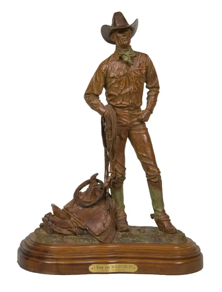 Bronze statue of a cowboy standing with a hat, hands on hips, holding a coiled rope at his side, on a wooden base.