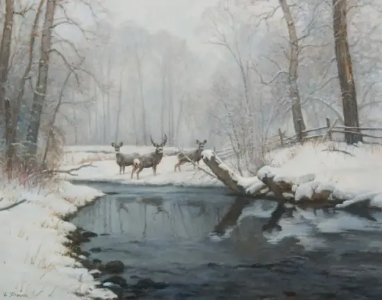 Three deer stand in a snowy forest beside a dark, partially frozen stream with bare trees overhead.
