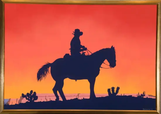 Silhouette of a cowboy in a hat riding a horse at sunset in a desert landscape, framed artwork.