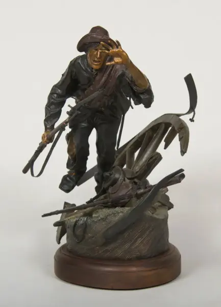 Bronze sculpture of an adventurer in a fedora, gripping a whip while stepping over rubble on a wooden base.