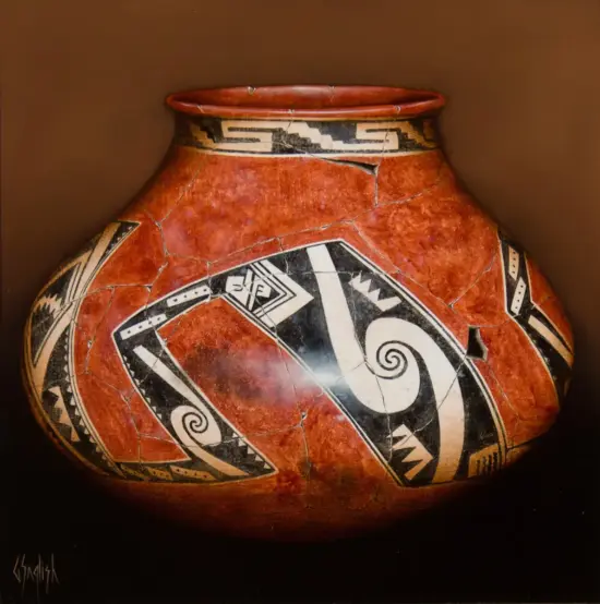 Red, cracked ceramic vase with bold black-and-white geometric decorations, close-up view of a Native American-inspired pot.