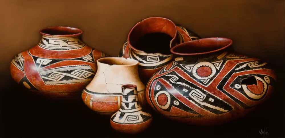 Group of red, black, and cream pottery vases with bold geometric patterns set on a dark background.