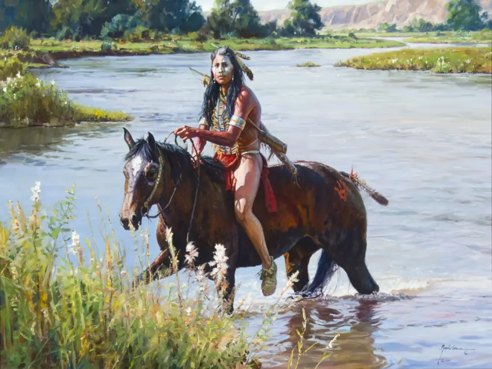 Native American man on horseback wading through a shallow river in a green, grassy landscape with trees in the background.