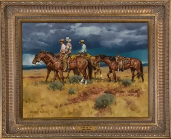 Framed painting of four cowboys on horseback riding across a desert under dark storm clouds.