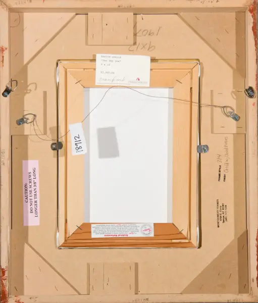 Back of a framed painting showing hanging wire, wooden frame, and gallery labels on a brown backing board with screws and tags
