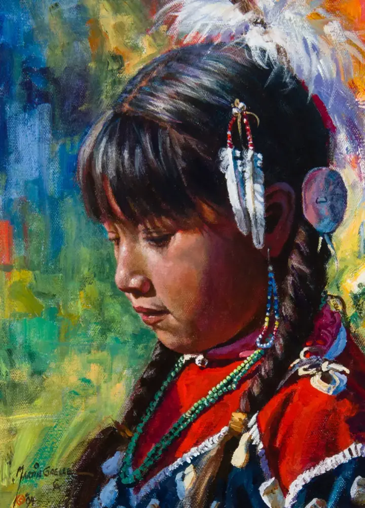 Portrait of a young woman in colorful traditional dress with beaded necklaces and feather hair ornaments, looking downward.