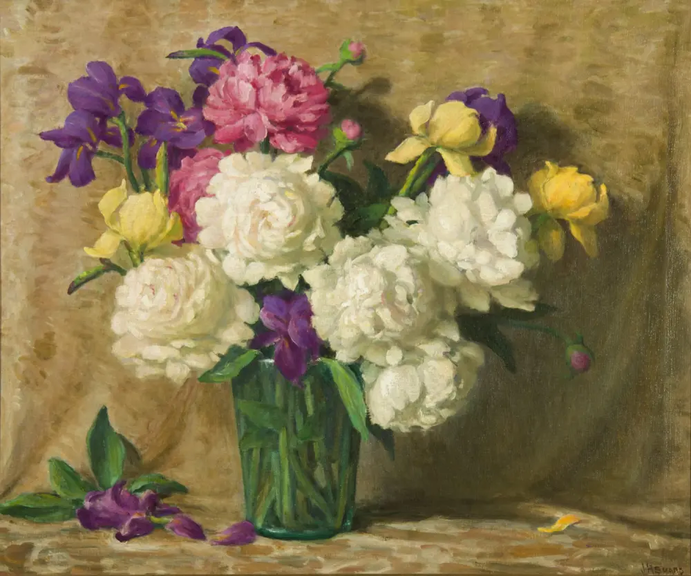 Colorful floral still life: purple irises, pink peonies, yellow roses in a green vase on a wooden table.