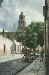 Colonial street scene with a tall church tower in the distance, white buildings, and cobblestone pavement; people market produce on the right.