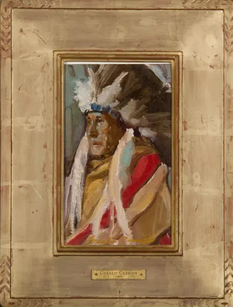 Framed painting of a Native American man in a feather headdress, enclosed by a gold ornate frame with a plaque reading Gerald Cassidy 1879–1934.