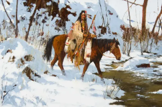 Native American man in fringed attire rides a brown horse through a snowy forest.
