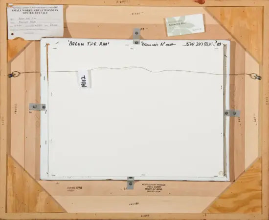 Back of a framed painting: wooden cradle, hanging wire, metal brackets, and gallery labels/stickers including the title 'Below the Rim' and a $5,000 price tag.