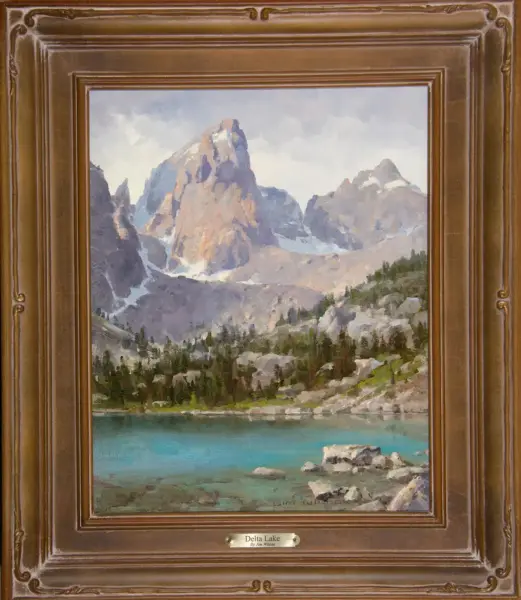Oil painting of a mountainous landscape with a turquoise lake in the foreground, framed in a brown ornate frame. The scene shows jagged peaks and evergreen trees under a cloudy sky, titled 'Delta Lake'.