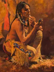 Native American man in fringe clothing sits cross-legged, applying face paint while looking into a small mirror in a warm-toned painting.