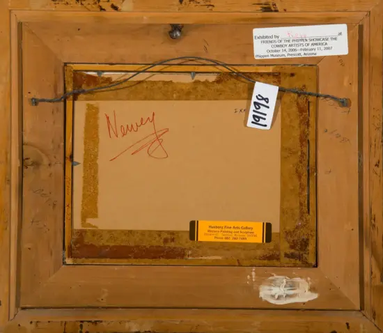 Back of framed artwork showing a wooden frame, a tangled hanging wire, and various labels/stamps including a small white label and an orange gallery label; red handwriting reading 'Money' on the canvas edge.
