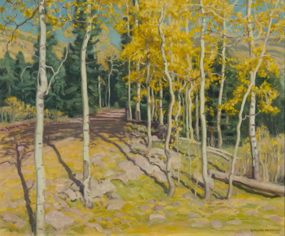 Autumn aspen grove with white trunks and golden leaves along a dirt path in a sunlit forest.