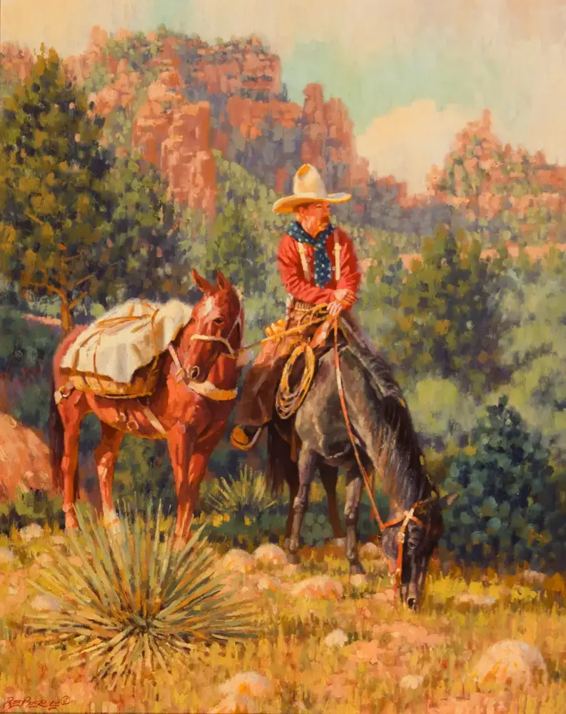 Cowboy in a red shirt and wide white hat rides a dark horse with a rope, on a trail with a pack horse nearby in a desert landscape.