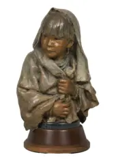 Bronze sculpture of a young girl in a hooded cloak, clasping the edges of her robe, on a wooden pedestal.
