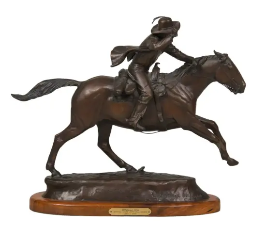 Bronze statue of a jockey riding a galloping horse on a wooden base, dynamic motion captured in mid-leap