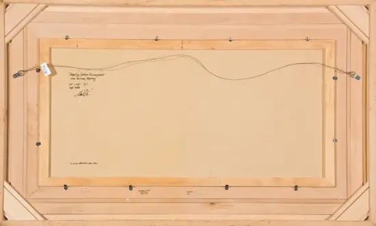 Back of a framed canvas showing the hanging wire across the top and handwritten notes about the artwork, titled 'Sleeping Indian Encampment' near Wilson, Wyoming, Sept. 2006.