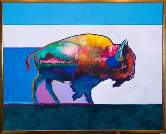 Rainbow-colored bison silhouette against a blue and white striped backdrop, in a framed painting.