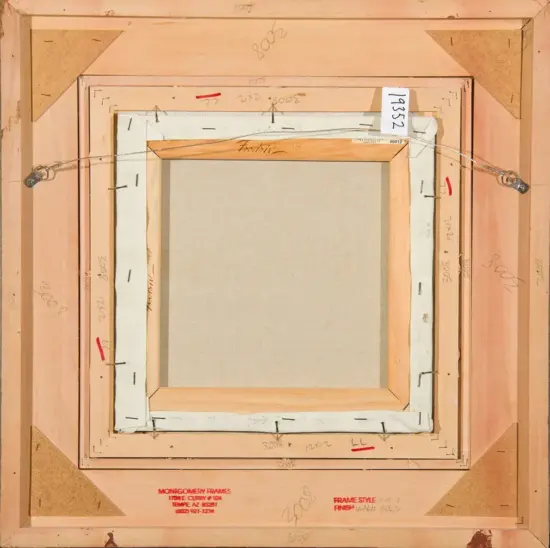 Back of a framed canvas showing wooden stretcher bars, staple wires, and hanging hardware with measurement markings and a small label on the frame.