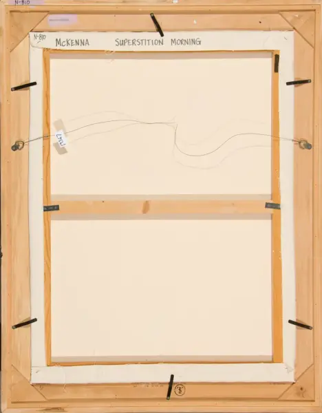 Back of a framed canvas showing hanging wires and clamps; the title 'McKENNA Superstition Morning' is written at the top edge.