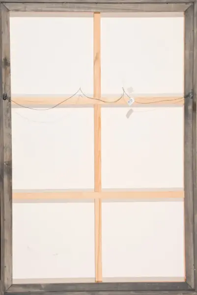 Back of a stretched canvas showing vertical and horizontal wooden stretchers and a hanging wire for mounting