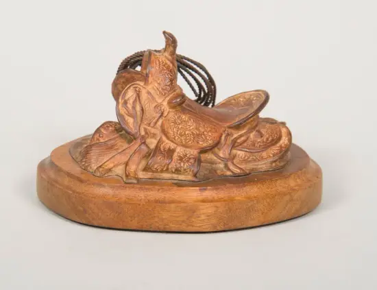 Wooden carved sculpture of two horses intertwined, with floral engravings, mounted on a round base; a decorative pedestal piece.