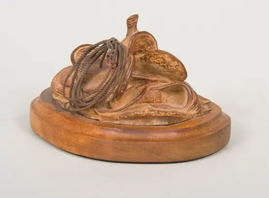 Wooden carved sculpture of a pair of sandals with a coiled rope, mounted on a round wooden base (decorative art)