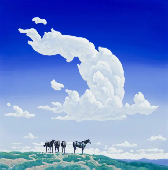Line of horses standing on a cloud-covered hill beneath a bright blue sky with white clouds.